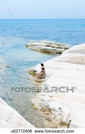Stock Photograph - Woman enjoying seaside, Punta Bianca National Reserve, Agrigento, Sicily, Italy. Fotosearch