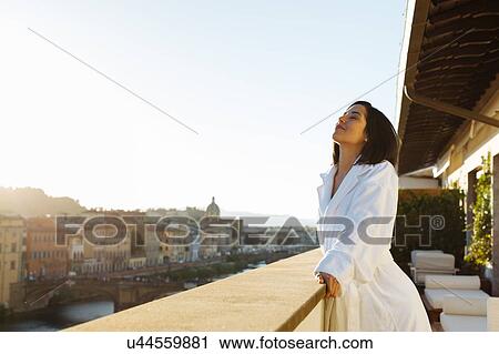 Woman enjoying sun on hotel balcony, Florence, Toscana, Italy View Large Photo Image Stock Image - Woman enjoying sun on hotel balcony, Florence, Toscana, Italy. Fotosearch