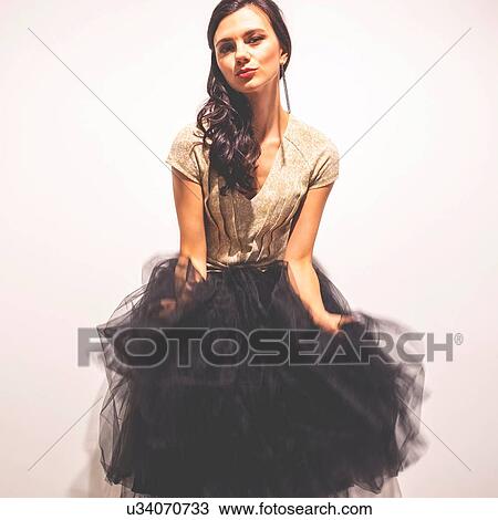Woman holding tulle skirt dancing View Large Photo Image Stock Image - Woman holding tulle skirt dancing. Fotosearch