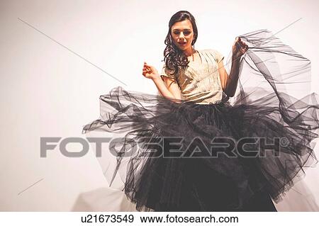 Woman holding tulle skirt dancing View Large Photo Image Stock Photo - Woman holding tulle skirt dancing. Fotosearch