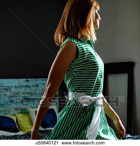 Stock Image - Woman in green summer dress. Fotosearch
