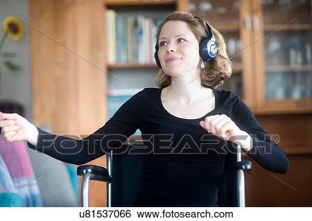 Woman in wheelchair dancing to music on headphones View Large Photo Image Stock Photograph - Woman in wheelchair dancing to music on headphones. Fotosearch