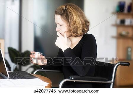 Woman in wheelchair working at laptop View Large Photo Image Stock Photography - Woman in wheelchair working at laptop. Fotosearch