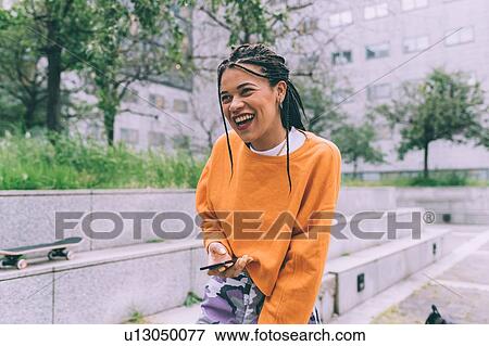Stock Photo - Woman laughing, Milan, Italy. Fotosearch