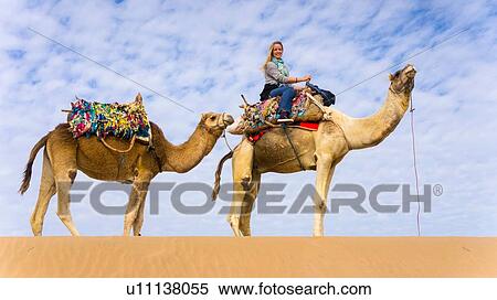Stock Photography - Woman on camel ride. Fotosearch