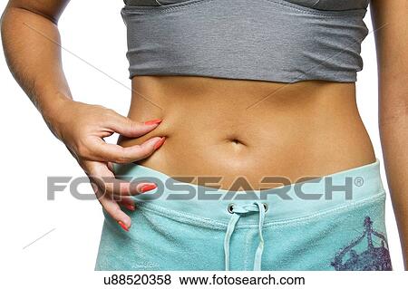 Stock Photo - Woman pinching waist. Fotosearch