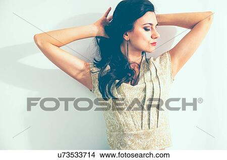Woman posing with hands behind head View Large Photo Image Picture - Woman posing with hands behind head. Fotosearch