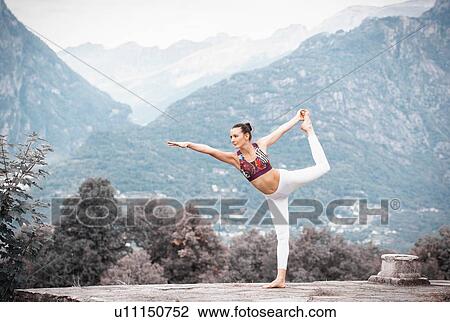 Woman practicing yoga, balancing on one leg in mountain landscape, Domodossola, Piemonte, Italy View Large Photo Image Stock Image - Woman practicing yoga, balancing on one leg in mountain landscape, Domodossola, Piemonte, Italy. Fotosearch