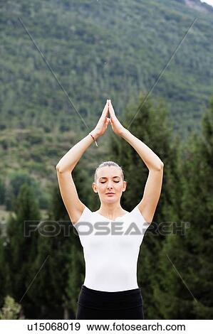 Woman practicing yoga, eyes closed and hands together View Large Photo Image Stock Photo - Woman practicing yoga, eyes closed and hands together. Fotosearch