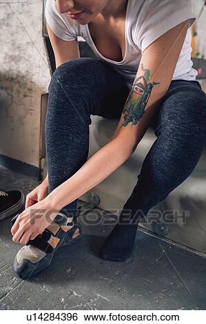 Woman putting on climbing shoes View Large Photo Image Stock Photograph - Woman putting on climbing shoes. Fotosearch