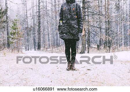 Stock Image - Woman standing in forest in winter, Ural, Sverdlovsk, Russia. Fotosearch