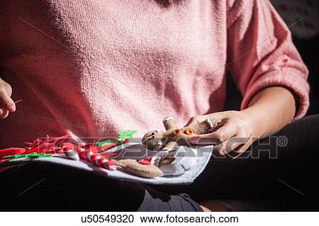 Woman stitching felt gingerbread man onto christmas decoration, mid section View Large Photo Image Stock Image - Woman stitching felt gingerbread man onto christmas decoration, mid section. Fotosearch