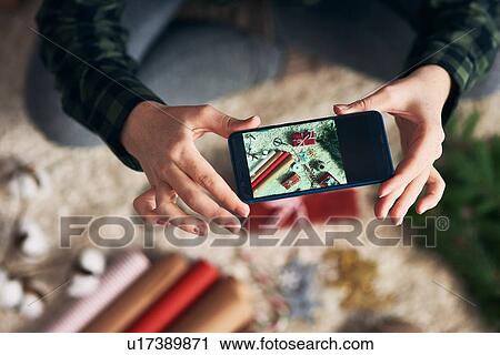 Woman taking photo of Christmas gifts and giftwrap View Large Photo Image Stock Image - Woman taking photo of Christmas gifts and giftwrap. Fotosearch