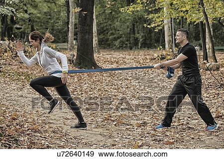 Woman training with resistance band View Large Photo Image Stock Photo - Woman training with resistance band. Fotosearch