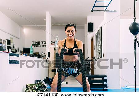 Woman using rope whips during workout in gym View Large Photo Image Stock Image - Woman using rope whips during workout in gym. Fotosearch