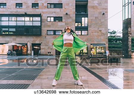 Woman welcoming rain in town square, Milan, Italy View Large Photo Image Stock Photo - Woman welcoming rain in town square, Milan, Italy. Fotosearch