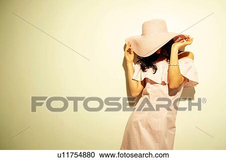 Woman with hat obscuring face View Large Photo Image Stock Image - Woman with hat obscuring face. Fotosearch