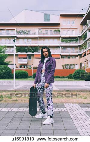 Woman with skateboard, Milan, Italy View Large Photo Image Stock Image - Woman with skateboard, Milan, Italy. Fotosearch