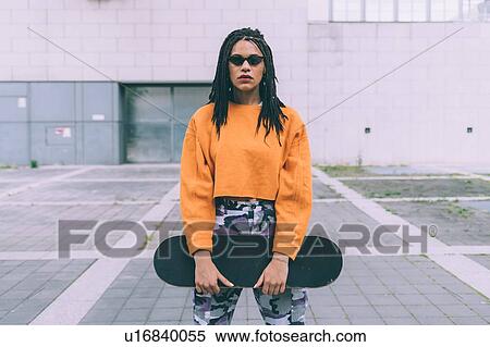 Woman with skateboard, Milan, Italy View Large Photo Image Stock Photography - Woman with skateboard, Milan, Italy. Fotosearch