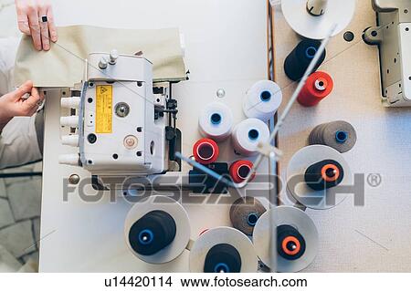 Picture - Woman working at sewing machine. Fotosearch