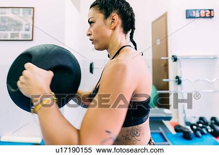 Woman working out in gym View Large Photo Image Stock Photography - Woman working out in gym. Fotosearch