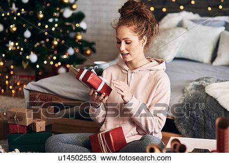 Woman wrapping Christmas presents View Large Photo Image Stock Image - Woman wrapping Christmas presents. Fotosearch