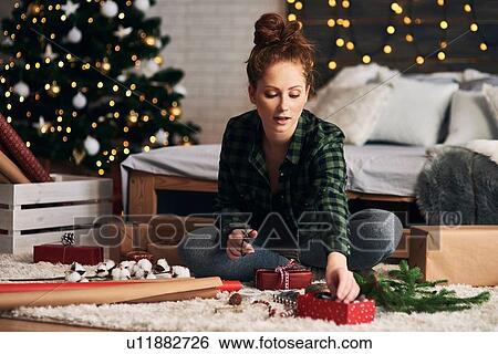 Woman wrapping Christmas presents View Large Photo Image Stock Photograph - Woman wrapping Christmas presents. Fotosearch