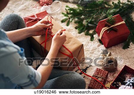 Woman wrapping Christmas presents View Large Photo Image Stock Photograph - Woman wrapping Christmas presents. Fotosearch