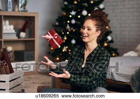 Stock Photography - Woman wrapping Christmas presents. Fotosearch