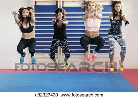 Women jumping in exercise class View Large Photo Image Stock Image - Women jumping in exercise class. Fotosearch