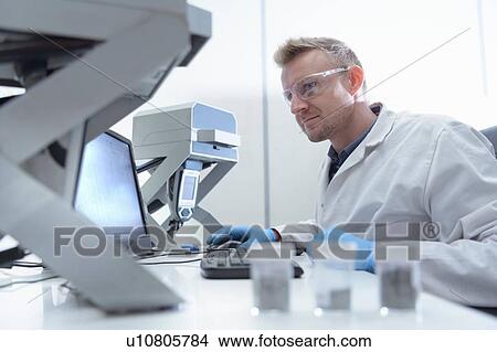 Picture - Worker inspecting samples in laboratory in recycling factory. Fotosearch