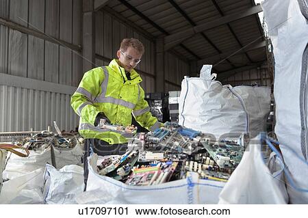 Worker sorting out old circuit boards for recycling in recycling factory View Large Photo Image Stock Image - Worker sorting out old circuit boards for recycling in recycling factory. Fotosearch