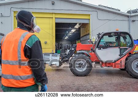 Workers loading vehicle batteries in vehicle battery recycling plant View Large Photo Image Stock Photo - Workers loading vehicle batteries in vehicle battery recycling plant. Fotosearch