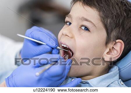 Young boy having dental check-up View Large Photo Image Stock Image - Young boy having dental check-up. Fotosearch