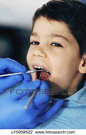 Young boy having dental check-up View Large Photo Image Stock Image - Young boy having dental check-up. Fotosearch