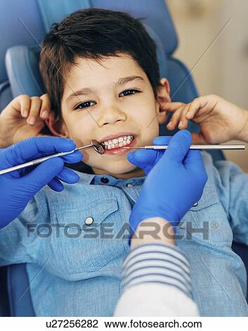 Stock Image - Young boy having dental check-up. Fotosearch