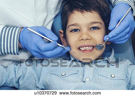 Young boy having dental check-up View Large Photo Image Stock Photo - Young boy having dental check-up. Fotosearch