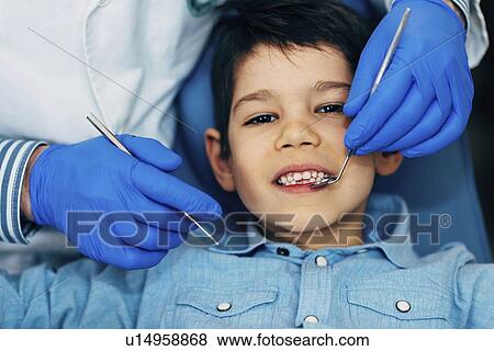 Young boy having dental check-up View Large Photo Image Stock Photo - Young boy having dental check-up. Fotosearch