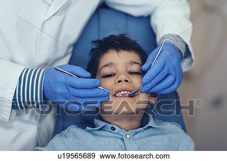 Young boy having dental check-up View Large Photo Image Stock Photo - Young boy having dental check-up. Fotosearch
