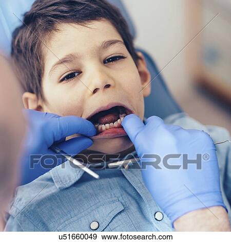 Stock Photo - Young boy having dental check-up. Fotosearch