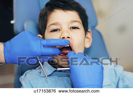 Young boy having dental check-up View Large Photo Image Stock Photograph - Young boy having dental check-up. Fotosearch