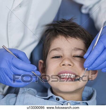 Stock Photography - Young boy having dental check-up. Fotosearch
