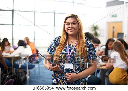 Young female higher education student in college classroom, portrait View Large Photo Image Picture - Young female higher education student in college classroom, portrait. Fotosearch