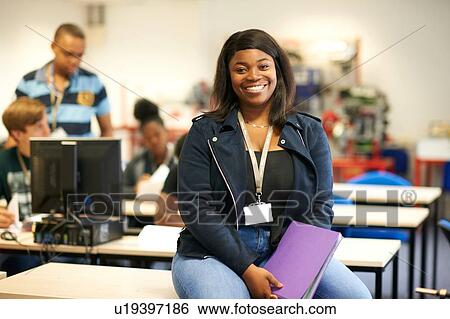 Young female higher education student in college classroom, portrait View Large Photo Image Stock Photograph - Young female higher education student in college classroom, portrait. Fotosearch