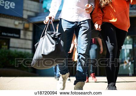 Young male and female higher education students leaving college campus, waist down View Large Photo Image Picture - Young male and female higher education students leaving college campus, waist down. Fotosearch
