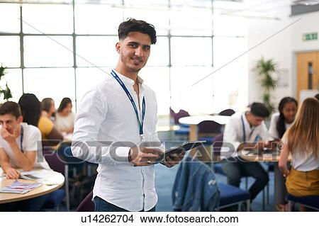 Picture - Young male higher education student in college classroom, portrait. Fotosearch