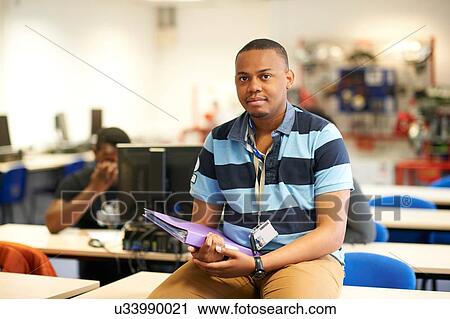 Young male higher education student in college classroom, portrait View Large Photo Image Stock Image - Young male higher education student in college classroom, portrait. Fotosearch