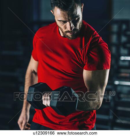 Stock Photograph - Young man exercising with dumbbells. Fotosearch