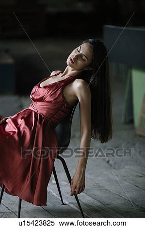 Young woman leaning back in chair View Large Photo Image Stock Photography - Young woman leaning back in chair. Fotosearch
