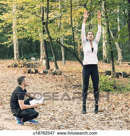 Stock Photo - Young woman training with personal coach. Fotosearch